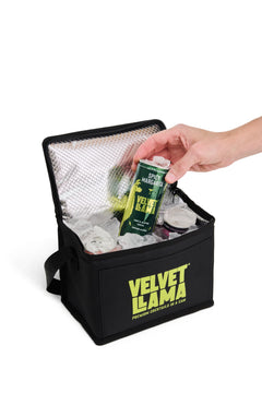 Hand placing a Spicy Margarita can into the cooler bag